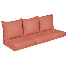 an orange couch with four pillows on it's back and two side facing each other