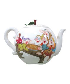 a teapot with cartoon characters painted on it