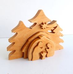 a wooden christmas tree with two people in the center and three trees on each side