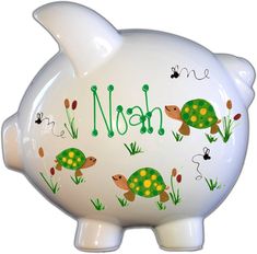 a ceramic piggy bank with the word noah painted on it