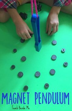 a child is playing with magnets on a green surface and the title reads magnetic pendulum