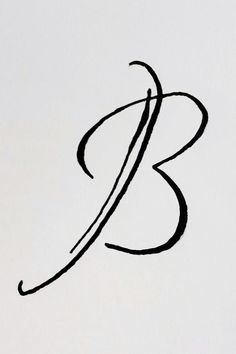 the letter b is written in cursive writing with a black ink pen on a white paper