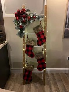 a ladder decorated with christmas stockings and lights