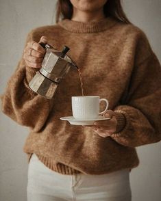 a woman is pouring coffee into a cup