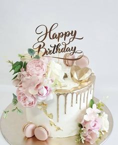 a birthday cake with pink flowers on top