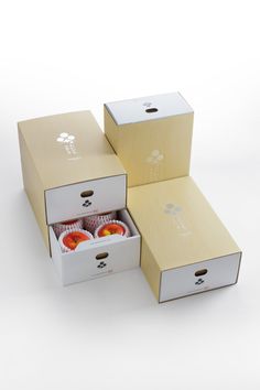 three boxes with food in them on a white surface