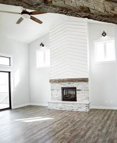 an empty living room with white walls and wood floors