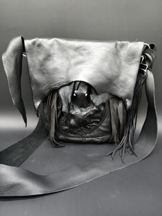 This double stitched pirate bag is made with premium cow hide leather. It has a large pocket on the back one inside and one hidden behind the tentacle deerskin for stash. It measures 10 inches wide and 11 inches deep. you can hook it to your belt or wear it cross body /shoulder. The strap will stretch so retie it to your desired length. ARRRRRRRRR Black Leather Gothic Bags, Black Gothic Leather Shoulder Bag, Gothic Leather Shoulder Bag For Travel, Gothic Leather Shoulder Bag For Daily Use, Gothic Leather Bags For Daily Use, Gothic Leather Bag For Everyday Use, Pirate Bag, Deer Skin, Hidden Pocket