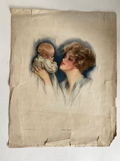 an old photo of a woman holding a baby in her arms and kissing it's face