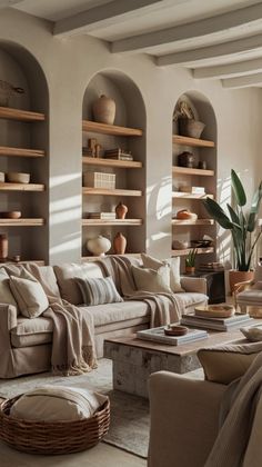 a living room filled with lots of furniture next to a wall covered in bookshelves