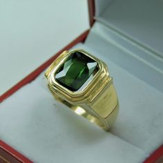 Gemstone: Green Tourmaline Treatments: None Color: As shown. A bright ring green. No olive tones. Clarity: Eye clean with no visible inclusions, just about flawless. Specifications: 10x8mm, 3.30 carats Cut: Cushion Origin: Brazil This is a stunning tourmaline. Please note: these rings are made to order, so you will notice that all the center stones are shown positioned on the ring mounting. This is a fine and classy example of what a bold masculine ring should look like. Perfect for a man, yet n Mans Ring, Olive Tone, Almandine Garnet, Ring Mountings, Solid Gold Rings, Green Tourmaline, Emerald Cut, Rings Statement, Tourmaline