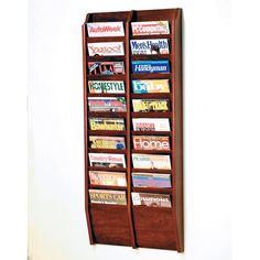 a wooden magazine rack with many magazines on it