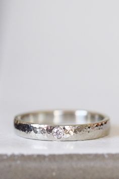 a white gold wedding band with three diamonds