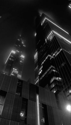 black and white photograph of skyscrapers at night