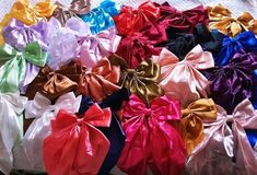 many different colored bows are stacked on top of each other