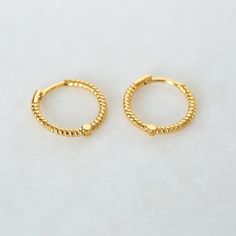 "A gorgeous classic - these little braided hoop earrings are understated and lightweight. Perfect for mixing and matching with other delicate earrings. * D E T A I L S * ∙ Sold individually (1 earring) or in pairs (2 earrings) ∙ Material: .925 Sterling Silver or 18K Gold Plated over .925 Sterling Silver ∙ Inner diameter: 10mm ∙ Hypoallergenic & nickel-free * P A C K A G I N G * ∙ All jewelry is sent out beautifully packaged in our signature box & ready for gifting. ∙ In order to reduce waste, we Trendy Hypoallergenic Yellow Gold Cartilage Earrings, Trendy 14k Gold-filled Yellow Gold Hoop Earrings, Trendy Adjustable Yellow Gold Earrings, Trendy Yellow Gold Hoop Earrings For Anniversary, Trendy 14k Gold Filled Huggie Earrings, Adjustable Hypoallergenic 14k Gold Filled Huggie Earrings, Trendy 14k Gold Hoop Earrings As Gift, Trendy Small Hoop Yellow Gold Earrings, Trendy Yellow Gold Huggie Earrings With Matching Set