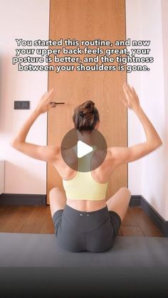 a woman is sitting on the floor doing yoga