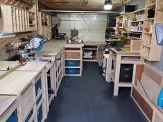 a room filled with lots of wooden work benches