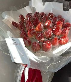 a bunch of strawberries are wrapped in plastic