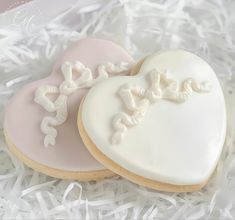 two decorated cookies in the shape of hearts