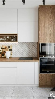 a modern kitchen with white cabinets and wood accents