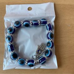 Brand New In Sealed Package Blue Evil Eye Beaded Bracelet With Hamsa Charm Blue Crystal Bracelet With Silver Beads, Blue Spiritual Bracelets With Letter Beads, Spiritual Blue Bracelets With Letter Beads, Blue Spiritual Bracelets With Large Beads, Blue Crystal Bracelet With 8mm Beads, Blue Spiritual Crystal Bracelet With Colorful Beads, Blue Spiritual Crystal Bracelet, Blue Evil Eye Round Beaded Bracelets, Blue Evil Eye Bracelet With Round Beads