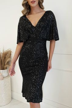 Coming in a range of colours, this sophisticated sequin midi is the perfect dress for black tie events, weddings or even a dressed up night on the town. It's super stretchy and comfy and the gorgeous "bat wing" sleeves are ideal for ladies who are conscious about their arms. Available in Navy, Black, Champagne, White & Rose Gold. Colour: Black Gorgeous sequin fabric Fit: True to size Fabric: Stretchy 100% polyester Model wears: Size small = UK 8 Model height: 5ft 10 (177cm) Dress Length: 107cm S Service Dresses, Bat Wing Sleeves, Black Tie Events, Wing Sleeves, Shimmery Dress, Sequin Midi Dress, Black Prom Dress, Midi Dress Black, Bat Wing