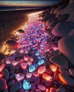 the beach is lined with glowing rocks and pebbles