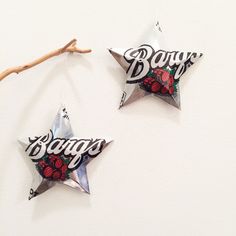 two star shaped ornaments hanging on a wall with the word bongo written in black and red