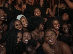 a group of women are smiling and posing for the camera