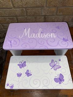 two step stools with purple butterflies on them and the name madison written in white