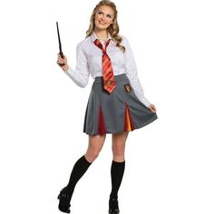 a woman dressed in a harry potter costume holding a wand and posing for the camera