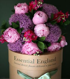 a bunch of flowers that are sitting in a vase with some purple and pink colors