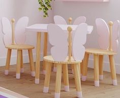 a group of children's wooden chairs and tables with butterfly shaped wings on them