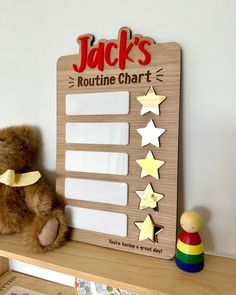 a teddy bear sitting on top of a shelf next to a wooden board with stars