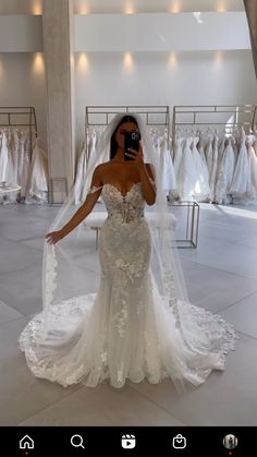 a woman taking a selfie in a wedding dress