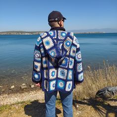 Unique special for man granny square blue hooded jacket can be gift for christmas. New Year Gift, Valentines Day gift for your boyfriend. Perfect gift for Father Day choice for your Dad. 🎁Unique gift handmade gift. This Retro Crochet Cardigan can be a unique hand knitted gift for your husband.🎁 🧶I knitted with high quality cotton acrylic blend yarns.(55% Cotton, 45% Acrylic) This men or women hooded cardigan can be worn in any season. DIMENSIONS: The measurements of the cardigan worn by our m Patchwork Afghan, Man Cardigan, Hippie Men, Crochet Waistcoat, Jacket Crochet, Sweater Colorful, Granny Square Cardigan, Afghan Coat, Square Cardigan