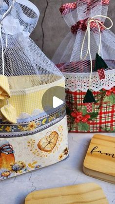 three wooden coasters with designs on them sitting next to a bag and some ribbon