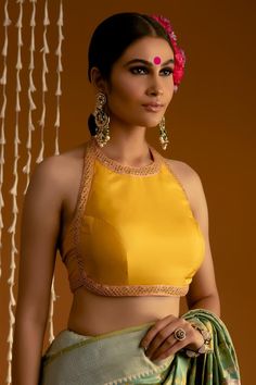 Yellow pure silk blouse with halter neck, multi color thread and sequin embroidered borders. Components: 1 Pattern: Embroidered Type Of Work: Thread and Sequin Work Neckline: Halter Neck Sleeve Type: Sleeveless Fabric: Pure Silk Color: Yellow Other Details:  Durable and wrinkle resistant Backless blouse Attached lining Closure: Back hook and eye Note: The saree, all the jewellery and hair accessory worn by the model are not being sold Occasion: Destination Wedding,Reception - Aza Fashions Halter Neck Blouse With Sleeves, Color Neck Blouses For Sarees, Halter Neck Blouse Design, Payal Khandwala, Halter Neck Blouse, Sleeveless Blouse Designs, Sleeveless Blouse Saree, Saree Jackets, Halter Neck Blouses