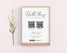 a pink and white business card next to a small flower on a light pink background