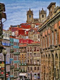 an old city street with many buildings in the background