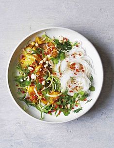 a white bowl filled with food on top of a gray countertop next to a knife and fork