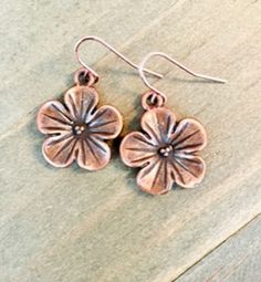 *Dangling Copper Flower Earrings *About One Inch Long *Perfect For Every Day Wear These pretty copper earrings are adorable. The copper plated flowers are light and come with rose gold ear wires. The minimalist earrings are definitely a pair that would match just about anything in your closet. They are about one inch in length. ~I use high quality hypoallergenic materials along with many different glass seed beads. I work hard to create beautiful pieces and to provide excellent customer service. Earring Gift, Jewelry Earring, I Work Hard, Beaded Hoop Earrings, Beaded Hoops, Flower Jewelry, Glass Seed Beads, One Inch, Copper Plated