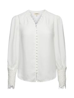 A sublimely chic blouse in ivory. Features vintage-inspired self-button-loop closure and extended cuffs done in exquisite scalloped guipure lace. Relaxed high-low silhouette gathered into band collar. Long sleeves with pleated caps. Front button closure. | L'AGENCE Ava Blouse Top In Ivory Cuffed Top, Lace Cuffs, Chic Blouses, Denim Blouse, Guipure Lace, Band Collar, Swimwear Accessories, Mandarin Collar, Black Blouse