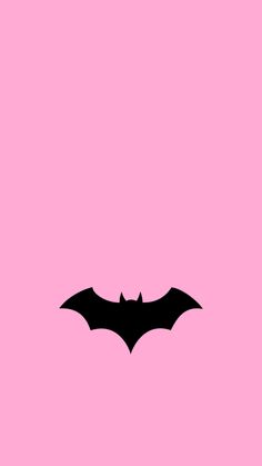 the silhouette of a bat on a pink background