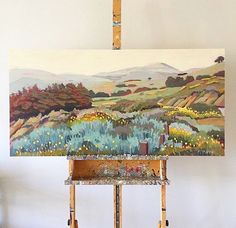 an easel with a painting on top of it