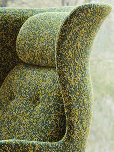 an upholstered chair with yellow and green speckles