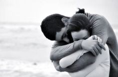 a man and woman hugging each other in front of the ocean with an inspirational quote