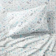 an image of a bed with blue and white sheets