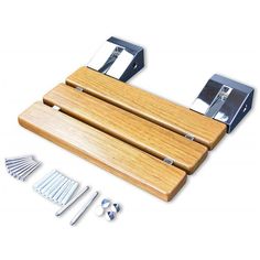 a wooden cutting board with four knives and two forks on it next to other tools